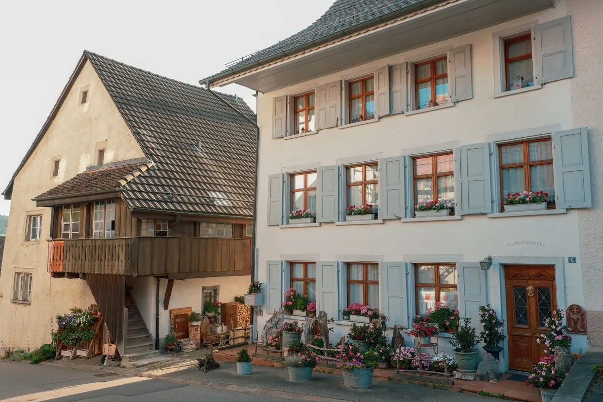 Traditional village houses with shutters and flower boxes, the kind of furnished holiday home that pays local taxes in France