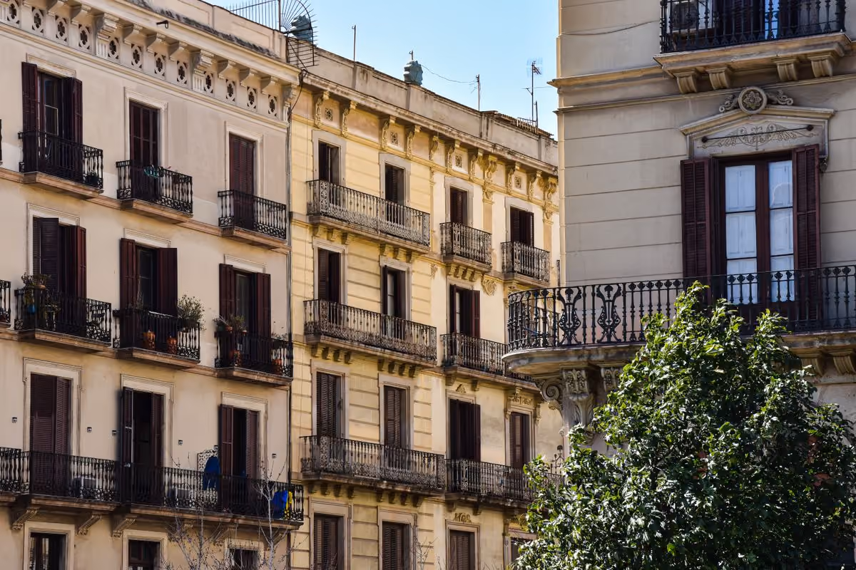 Classic apartment buildings with wrought-iron balconies in Barcelona, the kind of city centre housing at the heart of EU short-term rental rules