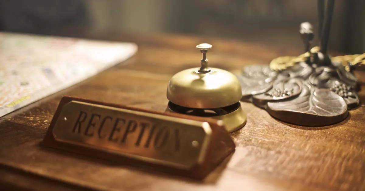 Old fashioned golden service bell and reception sign placed on wooden counter of hotel with retro interior - Picture by Andrea Piacquadio