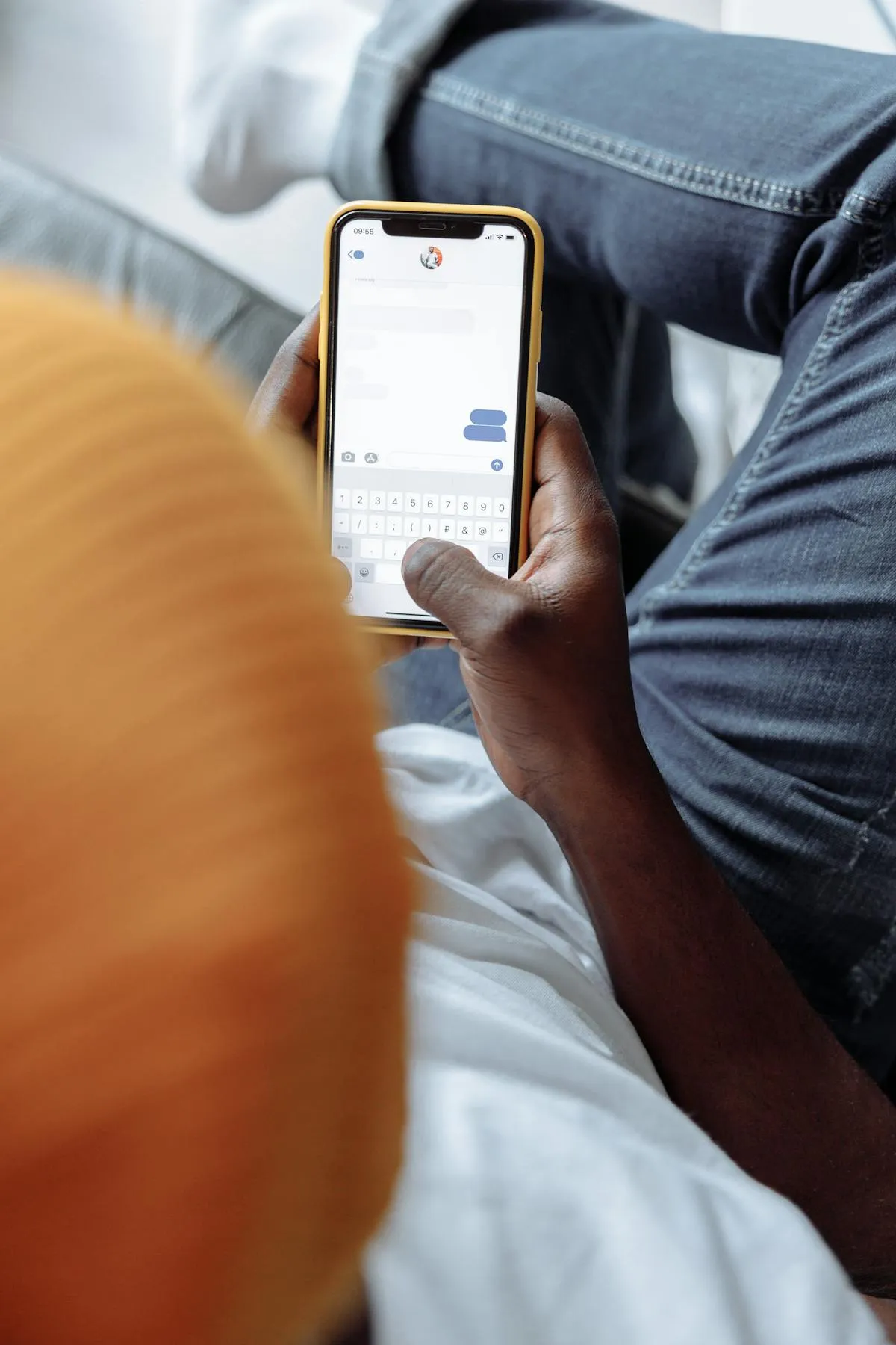 Person texting on smartphone with WhatsApp for guest communication