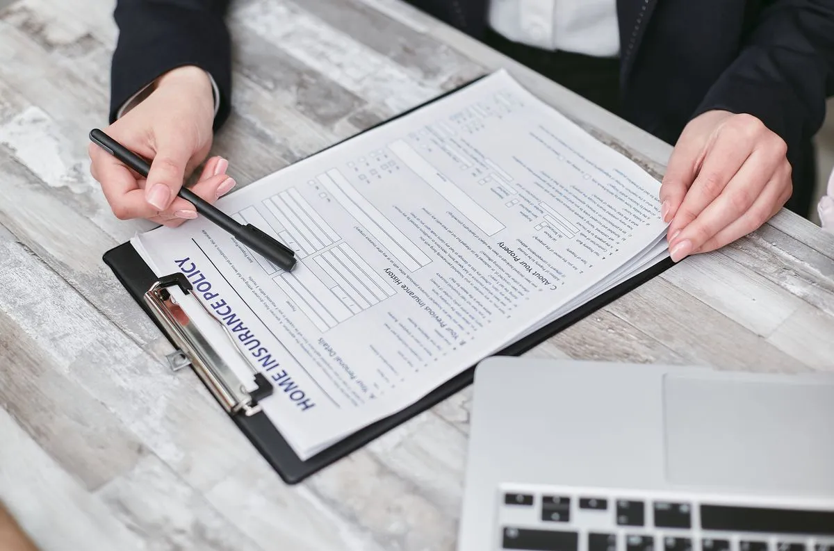 Hands reviewing a home insurance policy for a short-term rental