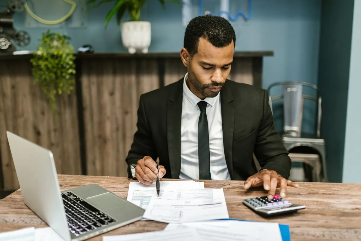 Property manager adjusting Airbnb rates for several listings from a laptop